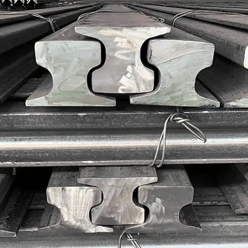 Stacked steel rails in storage yard