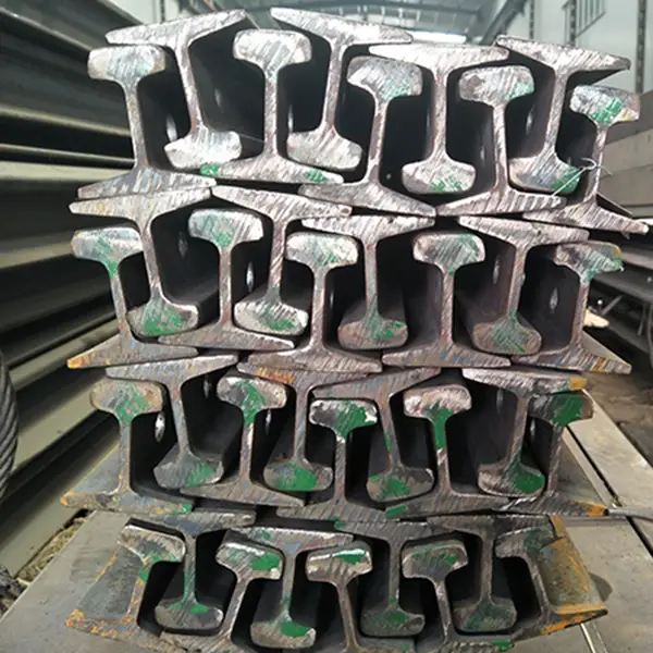Piled steel rails with green marks