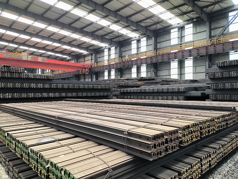 steel rails stored in warehouse for industrial rail supply and distribution
